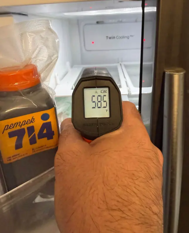 Infrared thermometer reading the temperature inside a refrigerator